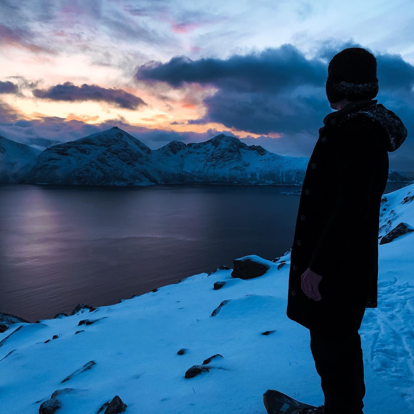 Taking a moment to catch our breath and take in the view after snowshoeing up the mountainside overlooking a Norwegian fjord.