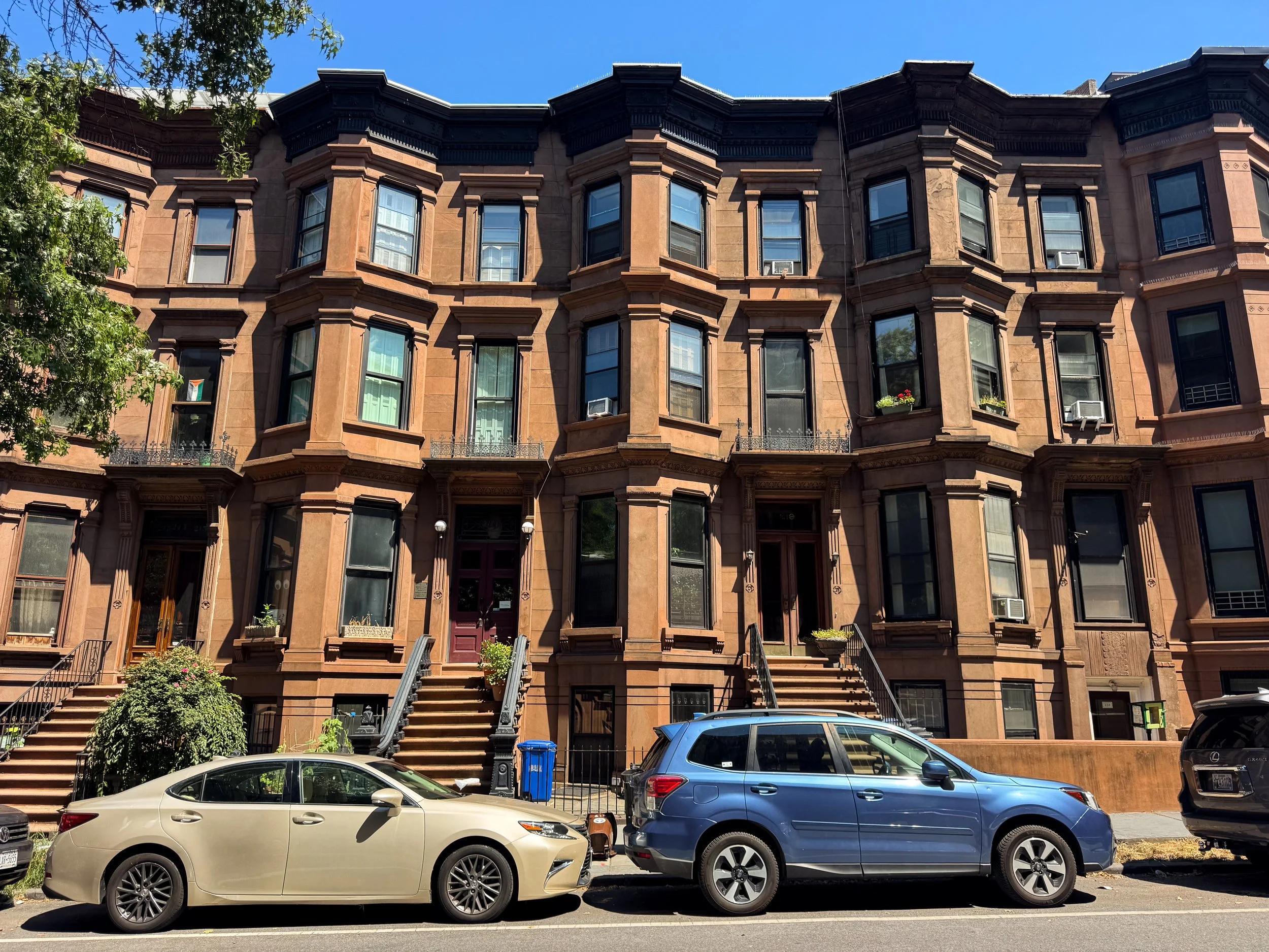 Historic Brooklyn brownstone row houses with stoops and brick facades on a residential street