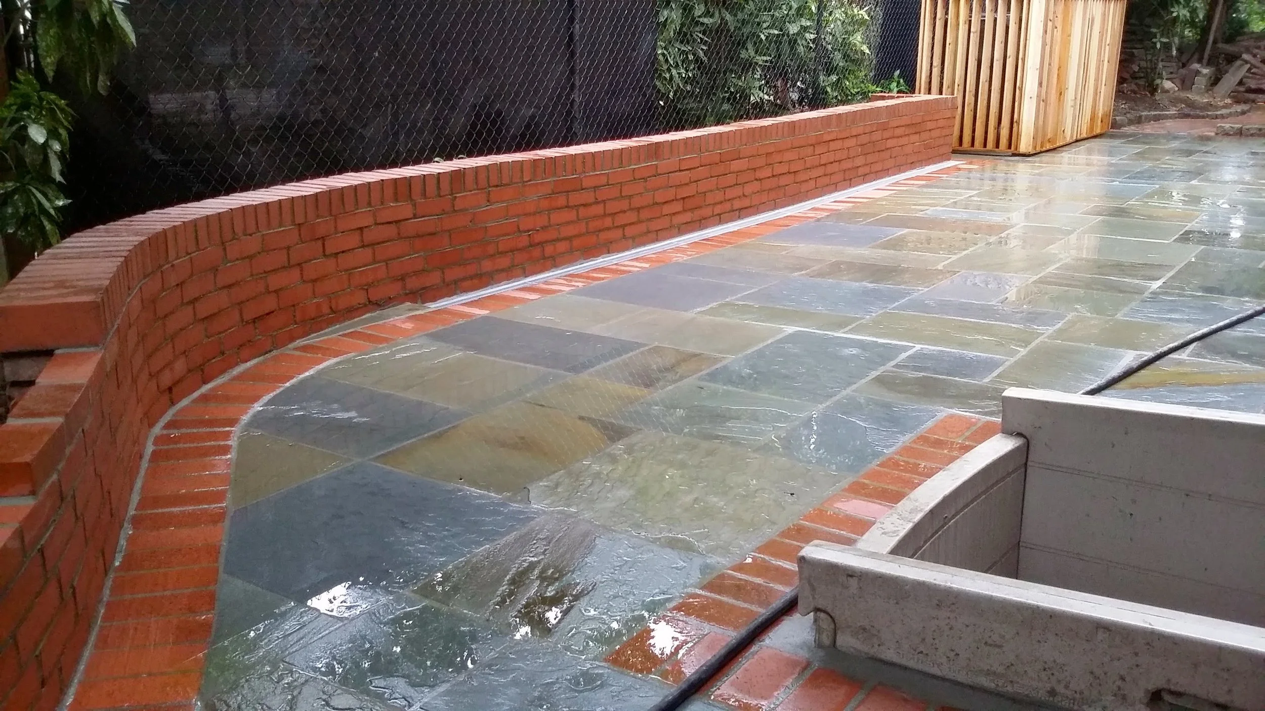 Natural Pennsylvania Flagstone with Brick Border and a Brick Sitting Wall