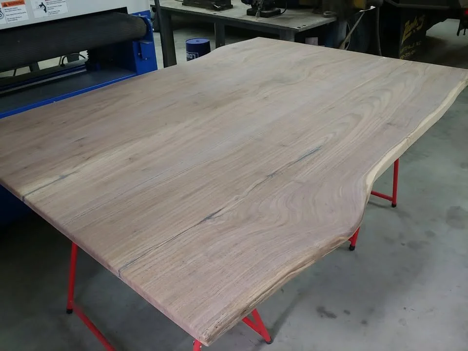 Black walnut islandtop, epoxy in cracks and sanded, but otherwise unfinished.