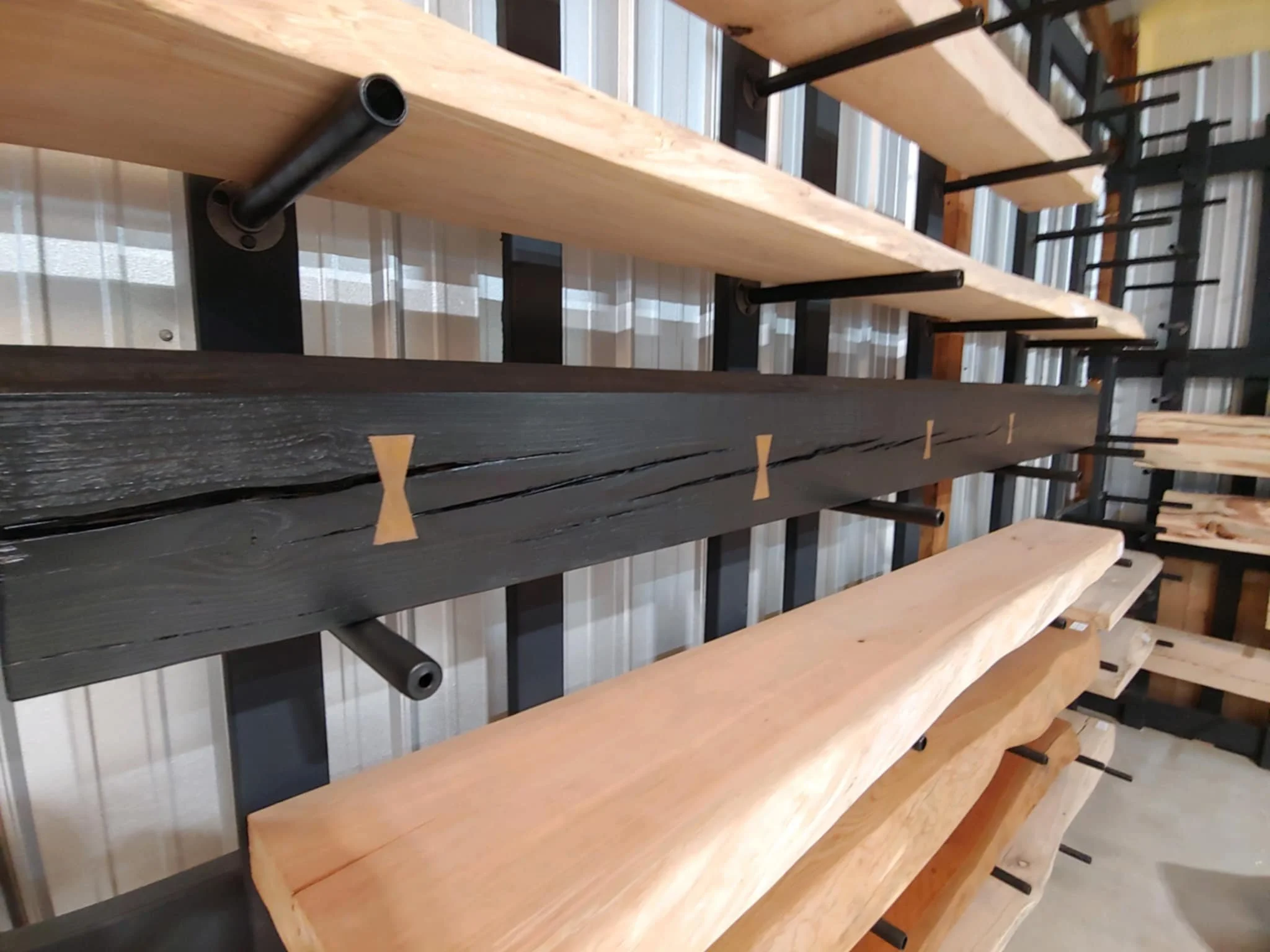 The Mantel Wall, featuring a dark-stained Hickory mantel with brass bowties