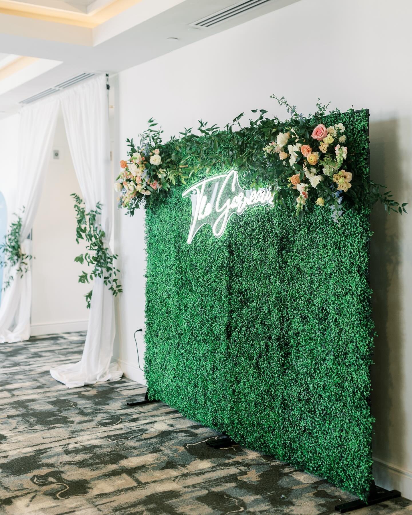 We are always looking for ways to make every detail feel unique to our couples &mdash; we love that for this photo-booth, we opted to upgrade their neon sign by using their new last name. This made the moment more personalized + gave them the perfect