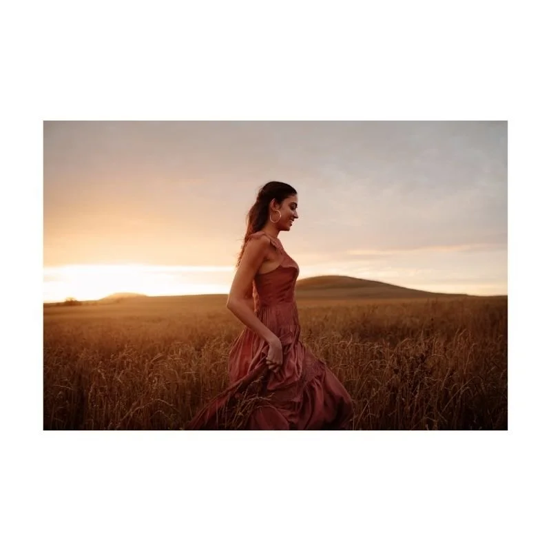 Woman walking through open field — nervous system healing and trauma therapy Texas