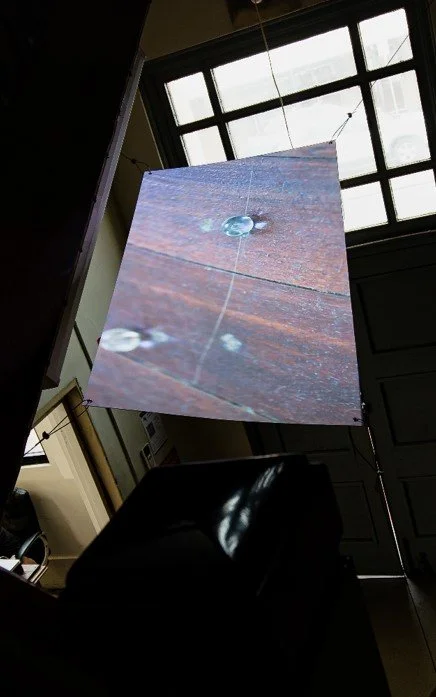 tandem projects, "...everything moves in straight lines over the curved landscape of spacetime"[1], 2021, double-sided substrate, projectors, suspension wire, fixings. Image courtesy of the artists. [1] Brian Cox, 'Brian Cox's Adventures in Space and