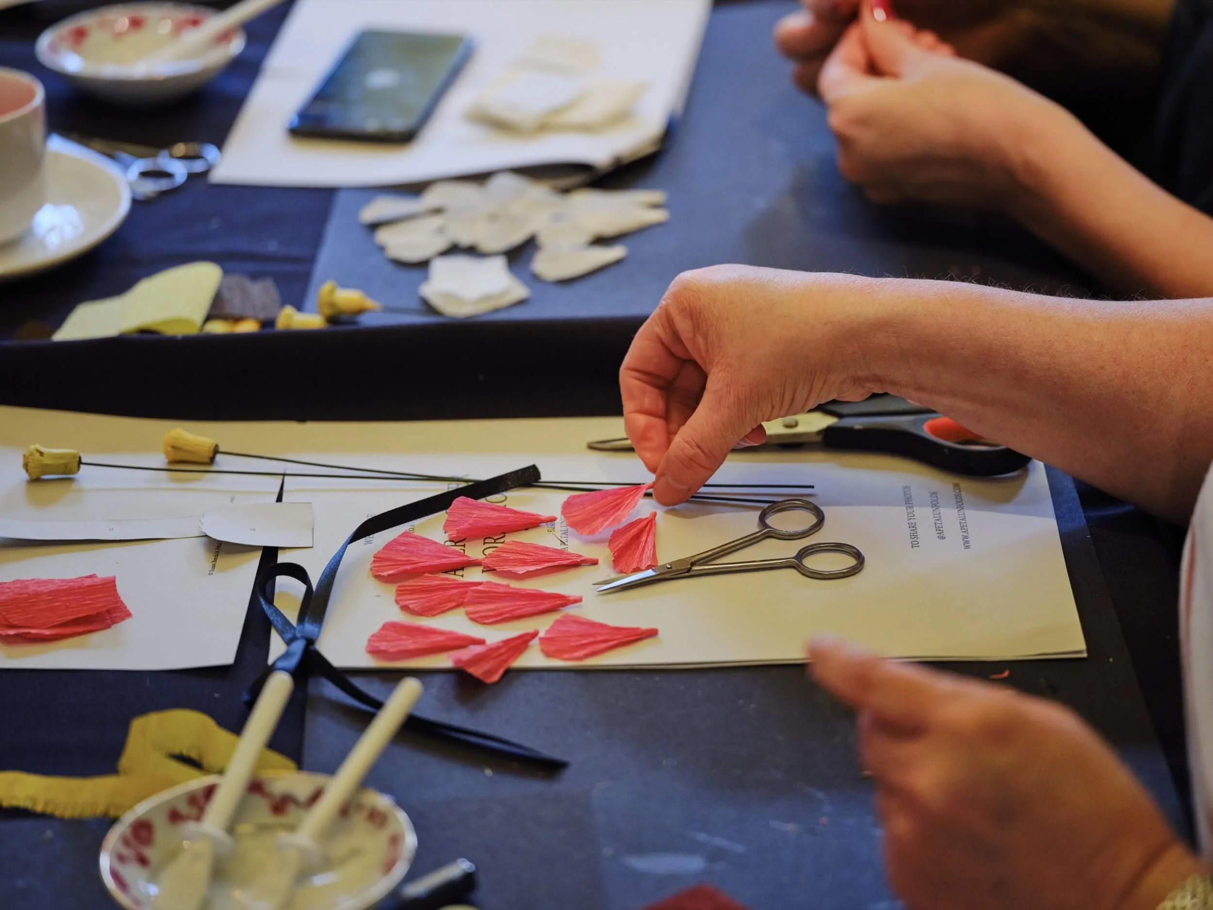paper petals on table a petal unfolds workshop