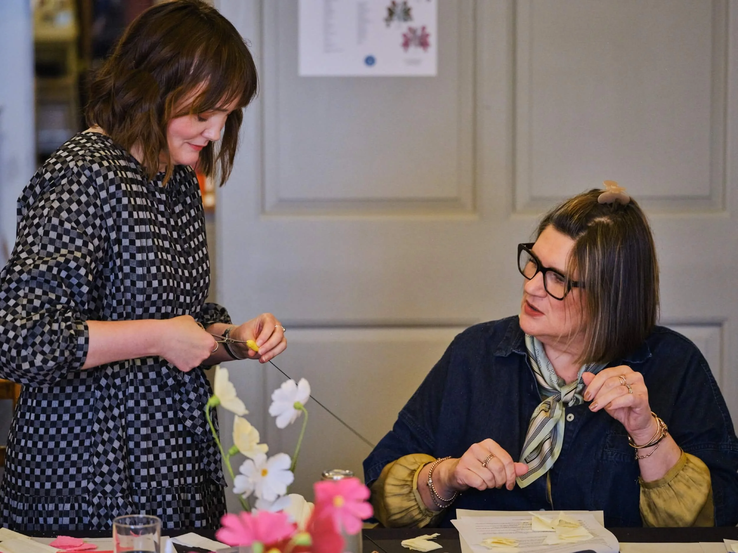 paper flower workshop assisting student a petal unfolds