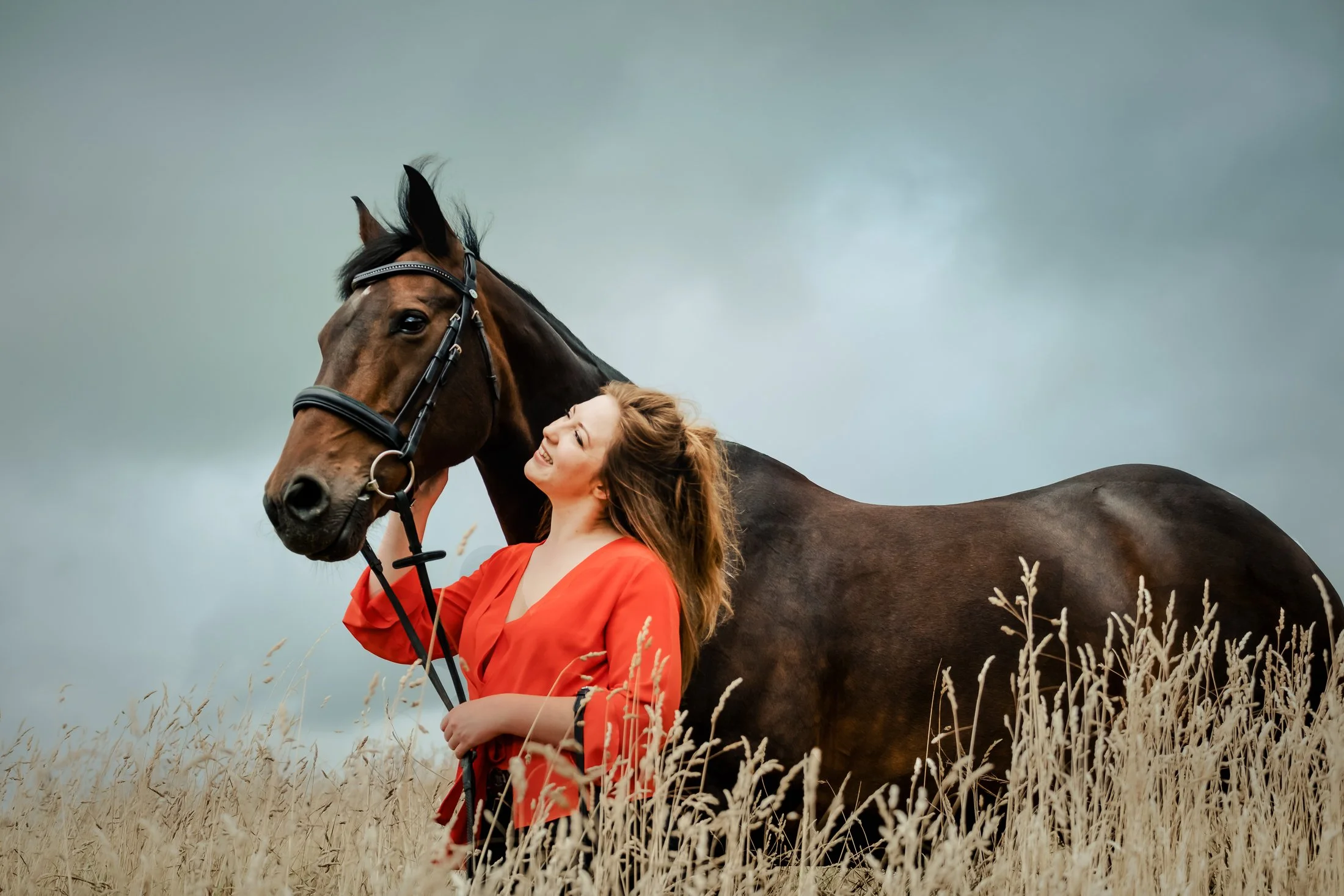 a lady with her horse in long grass at Foremark Reservoir