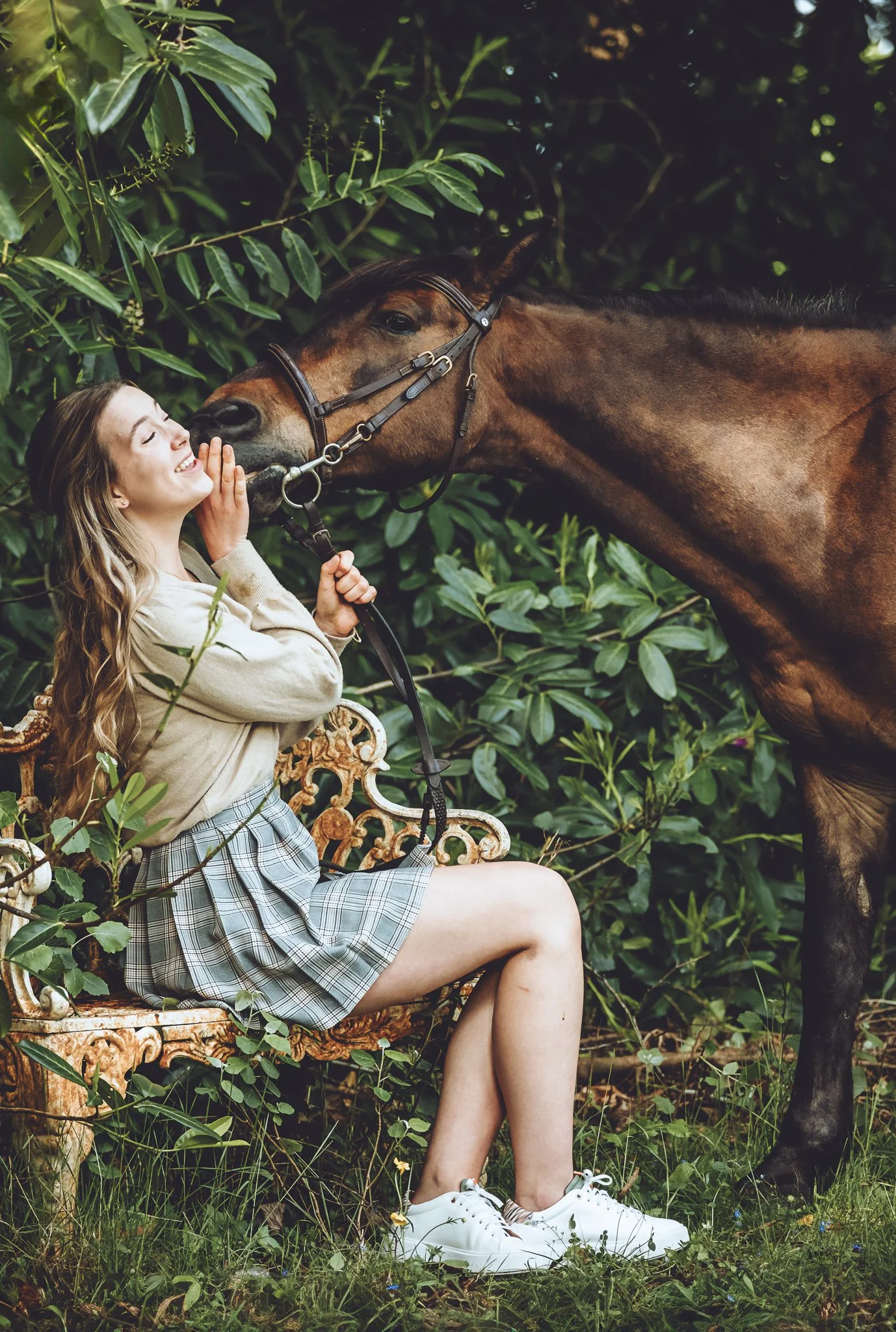 Young rider with her bay roan pony in woodland