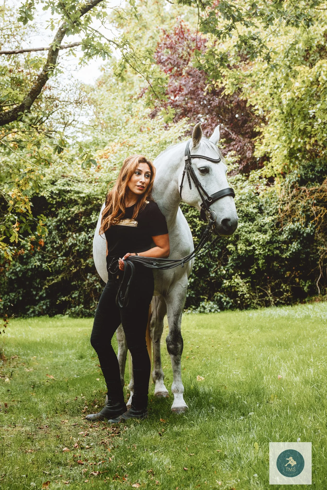 Pari standing beside her horse Ferrari during their equine portrait session in Leicestershire
