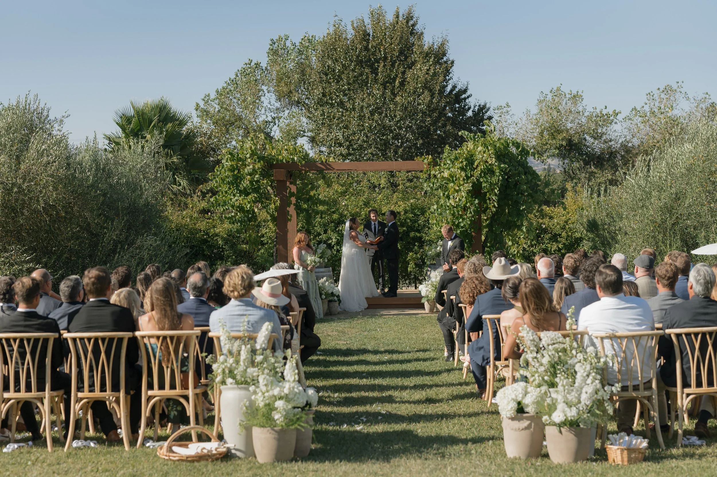 Some favorite frames from Sarah &amp; Vinny&rsquo;s ceremony @lavender.oak 🤍 A mix of digital + film 🎞️ 
The cutest flower girls, the grapevines above them, Sarah&rsquo;s sister at her side, their guests waving ribbons for their recessional, ugh so