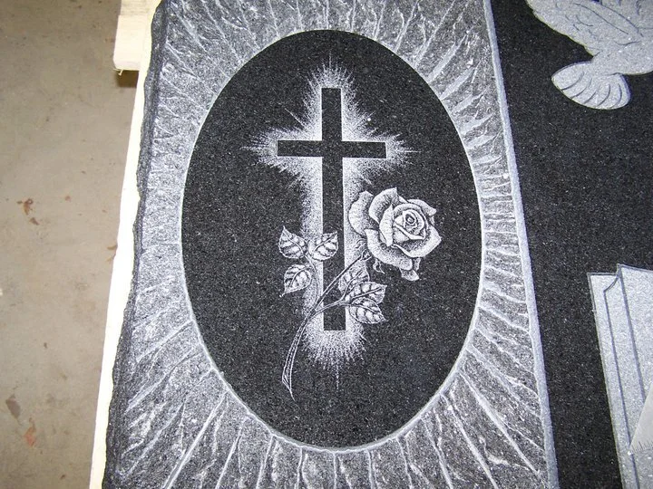 Carved tombstone with cross and rose design