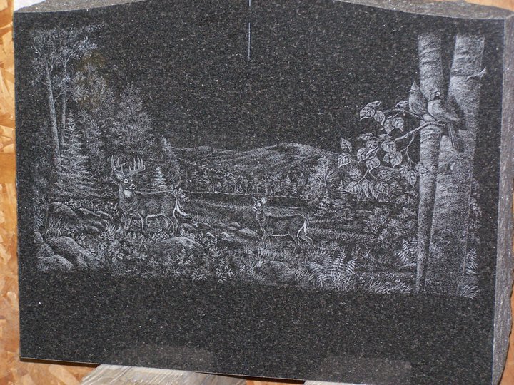 Etched stone with deer in forest scene