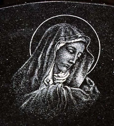 Engraving of religious figure with a halo on black surface