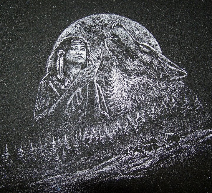 Artistic depiction of a Native American figure with a headband and feathers, raising their hands. A howling wolf and full moon are in the background, with a forest and pack of wolves below.