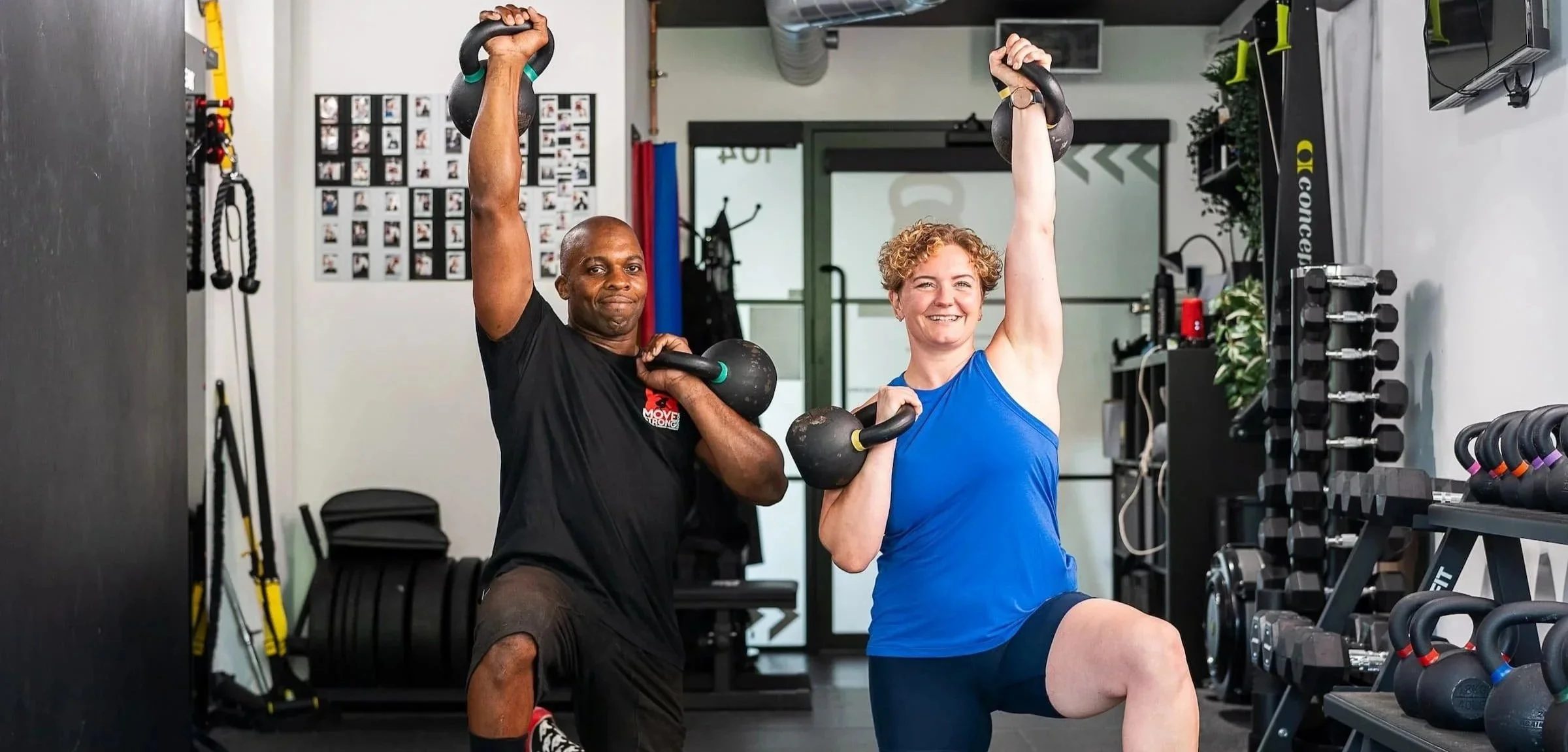 Two personal trainers in the Move Strong London studio lifting kettlebells
