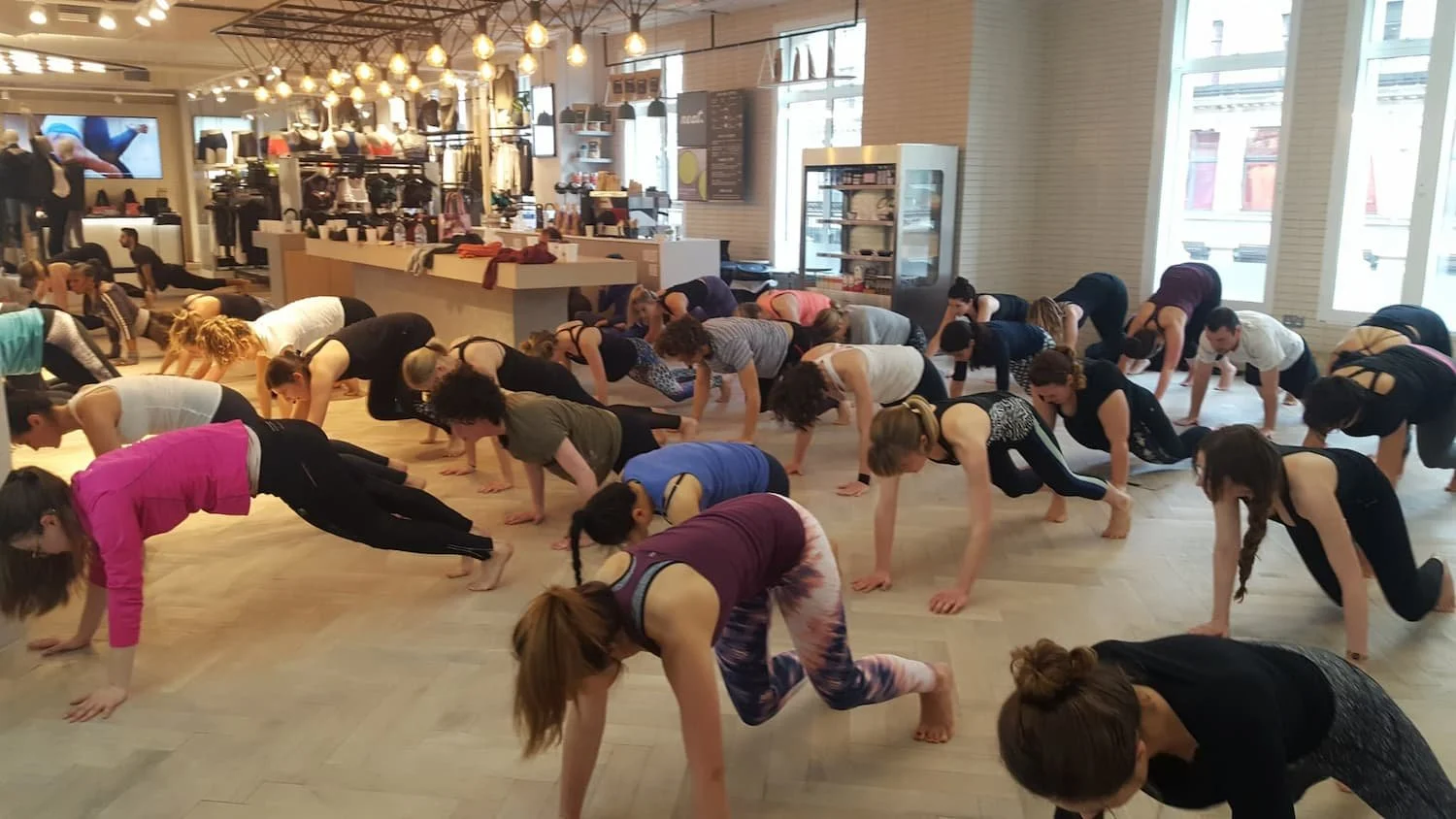large group fitness class based in an large open reception space at Lululemon
