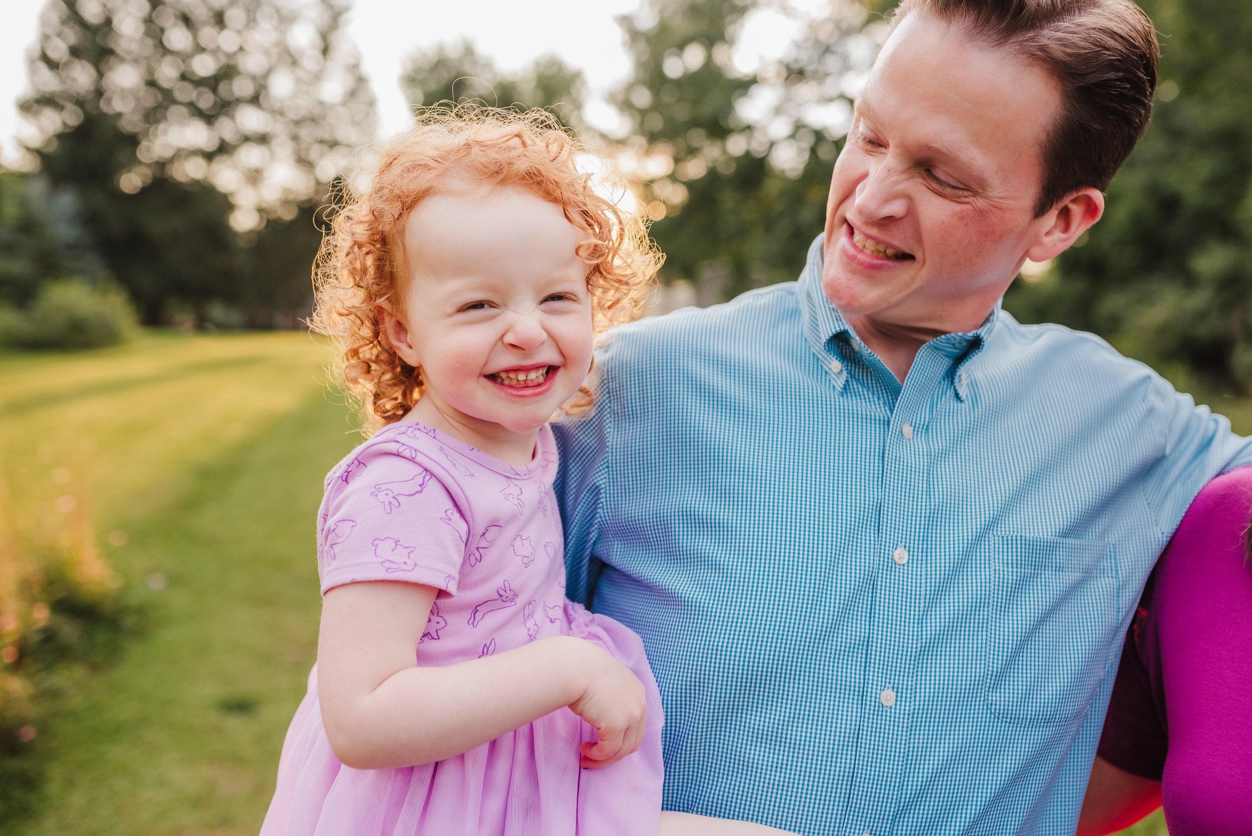 Girl smiling in field with her Dad in Orchard Park, NY
