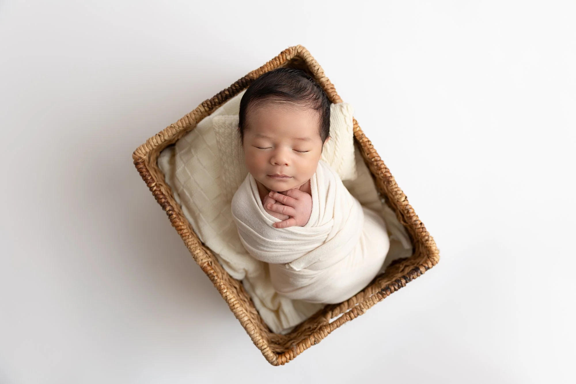 Newborn baby sleeping on a white background.