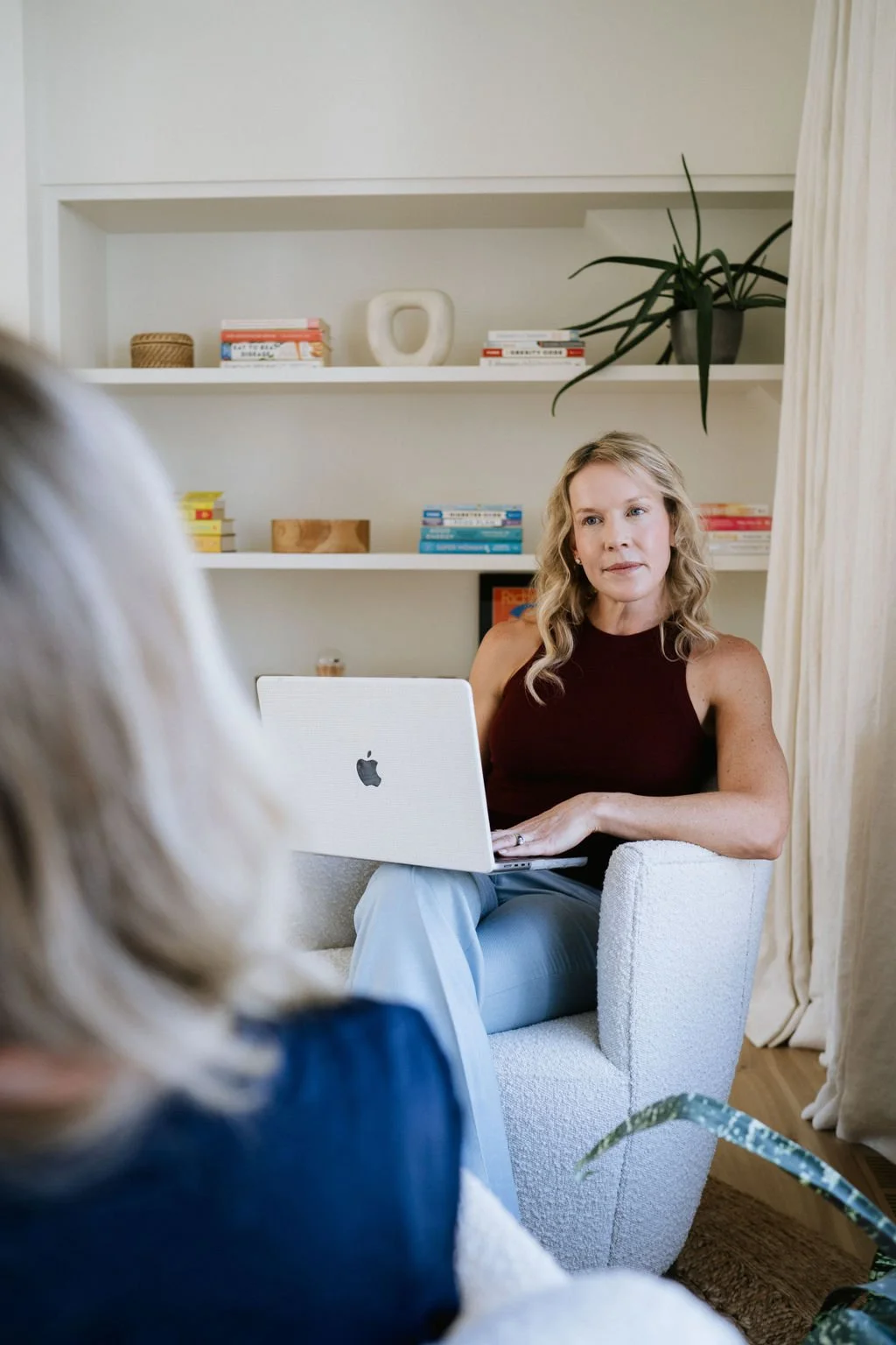 Taryn sitting at computer with a client consulting about peptide therapy