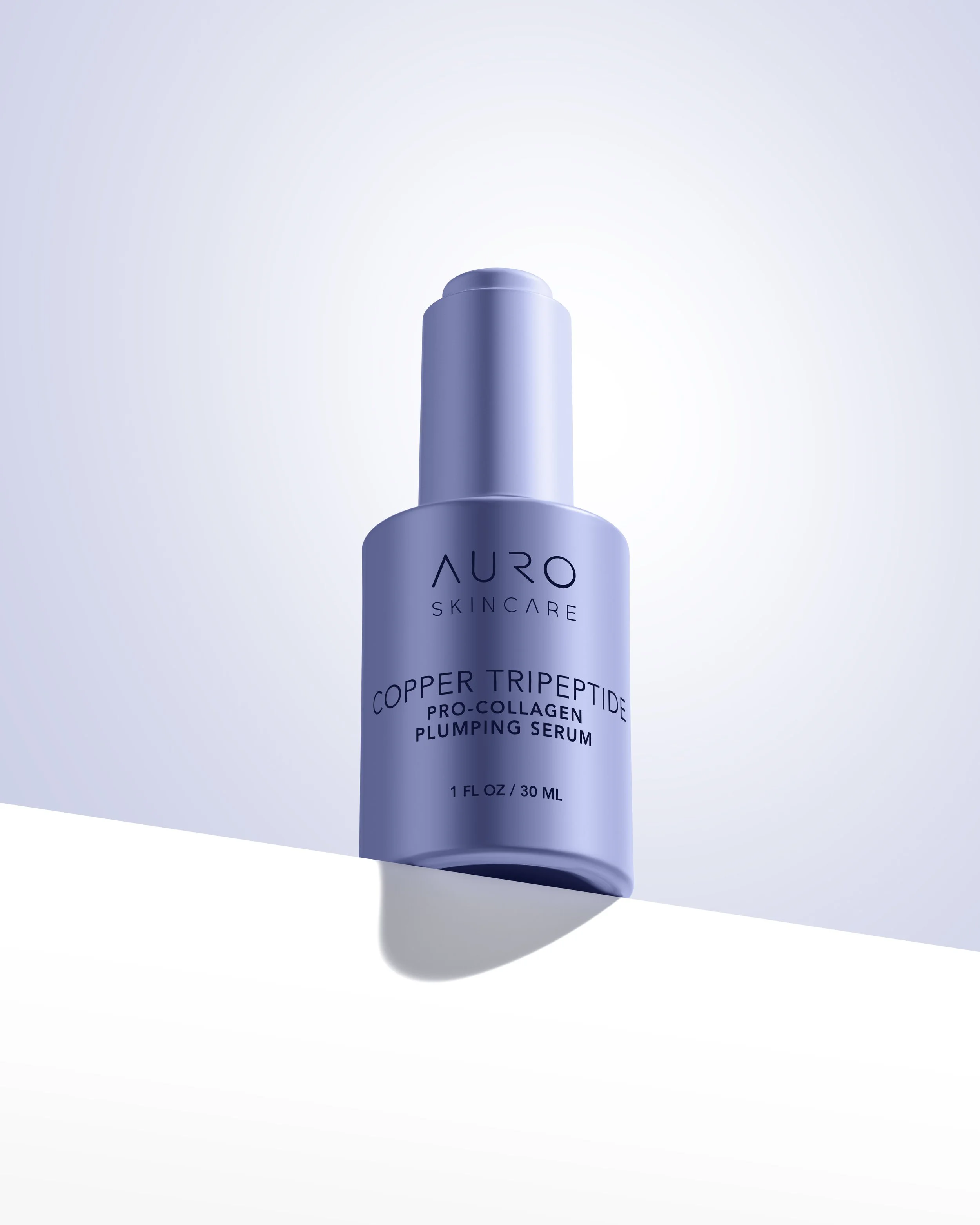 Minimal studio product photography of a blue skincare bottle on a light background.