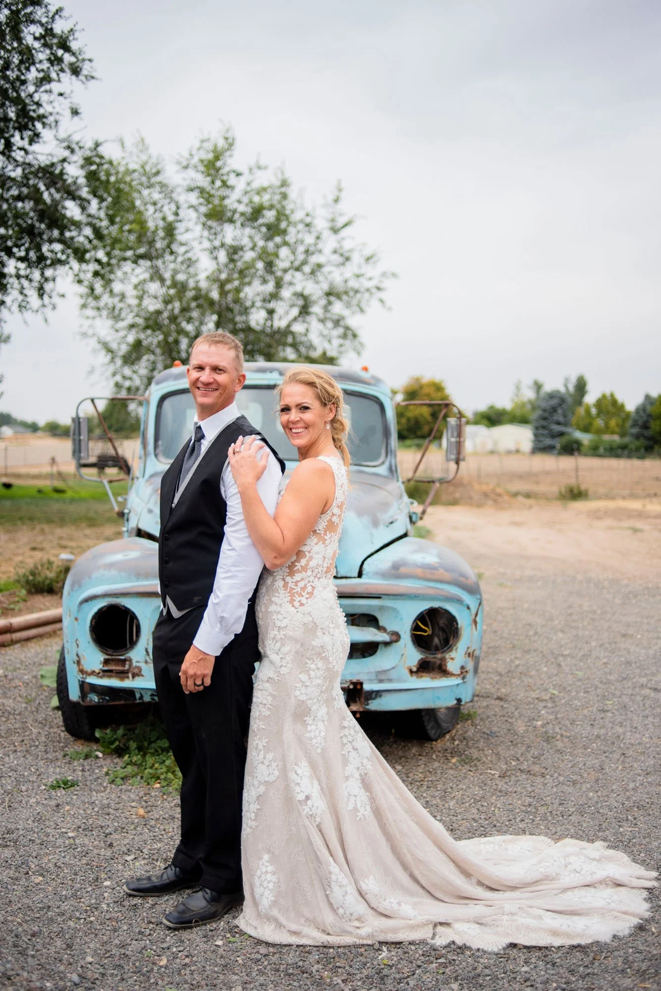 Nampa-Idaho-wedding-Antique-truck-bride-groom-wedding-dress-suit-smiles.jpg