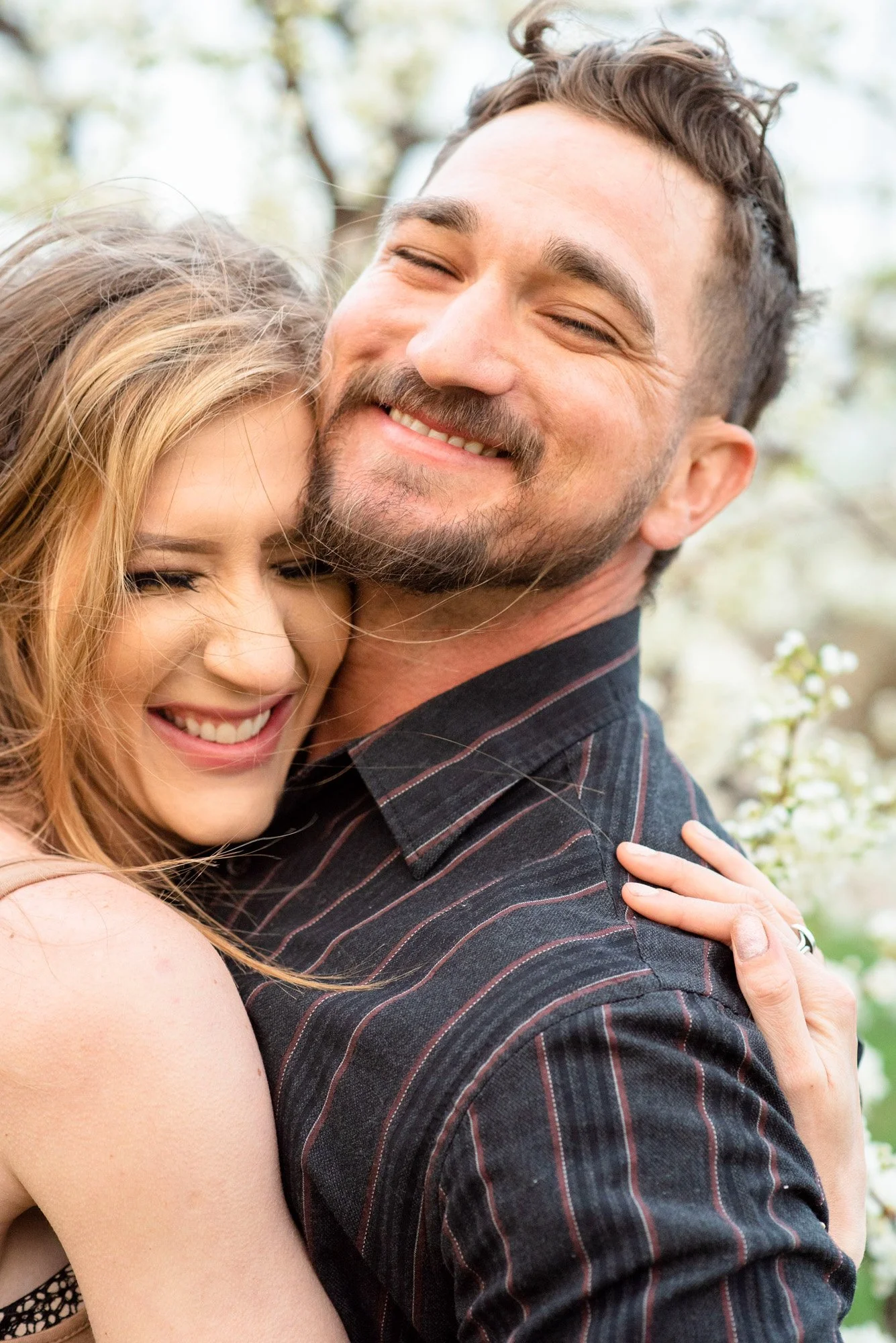 Engagment-photographer-Emmett-Idaho-Gem-County-cherry-blossoms-candid-laughing.jpg