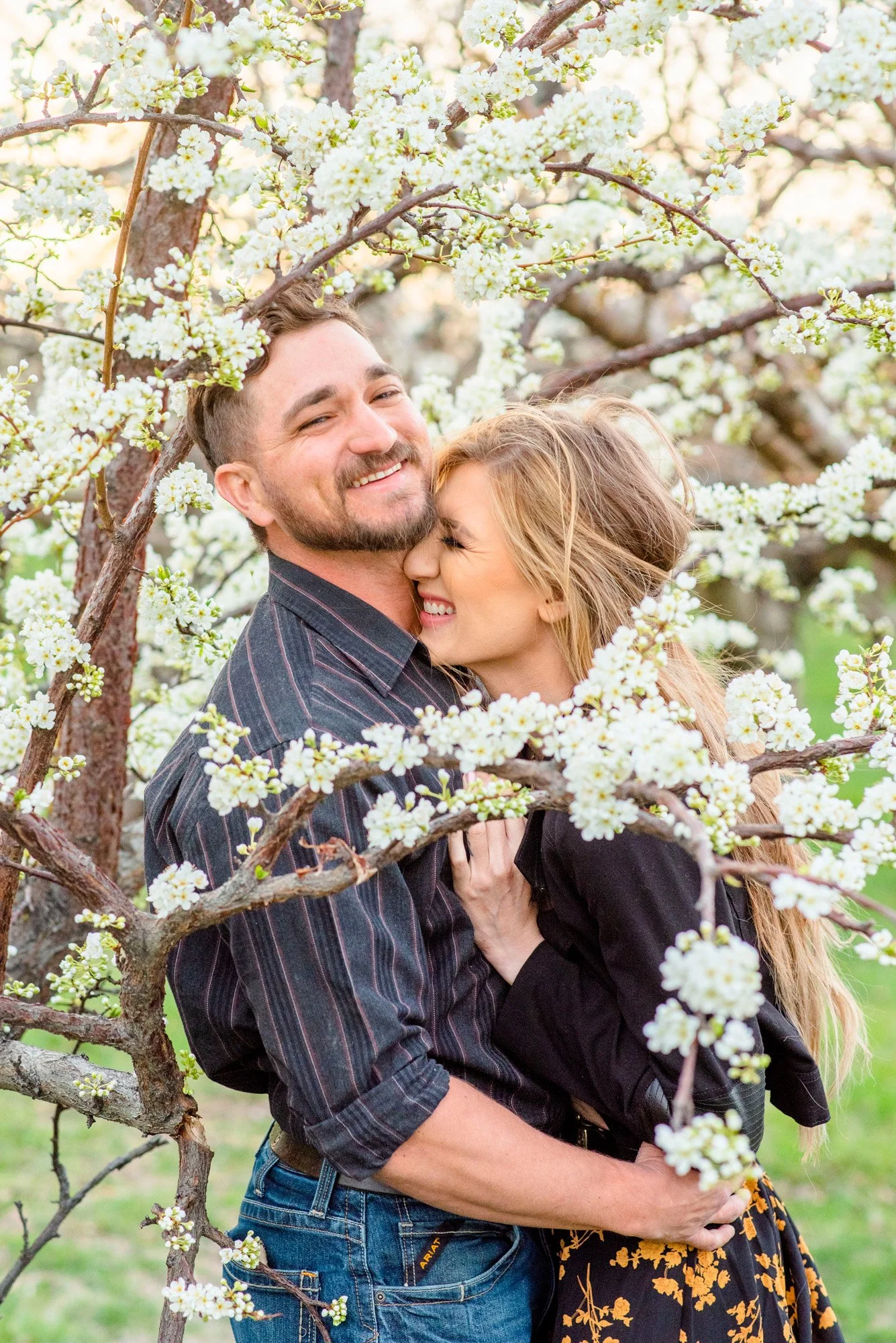 Couple-in-white-cherry-blossoms-flowers-candid-Emmett-Idaho-Photographer.jpg