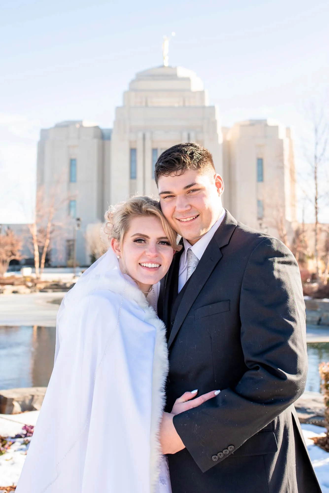 Couple posing at the Meridian Idaho Temple for their marriage.