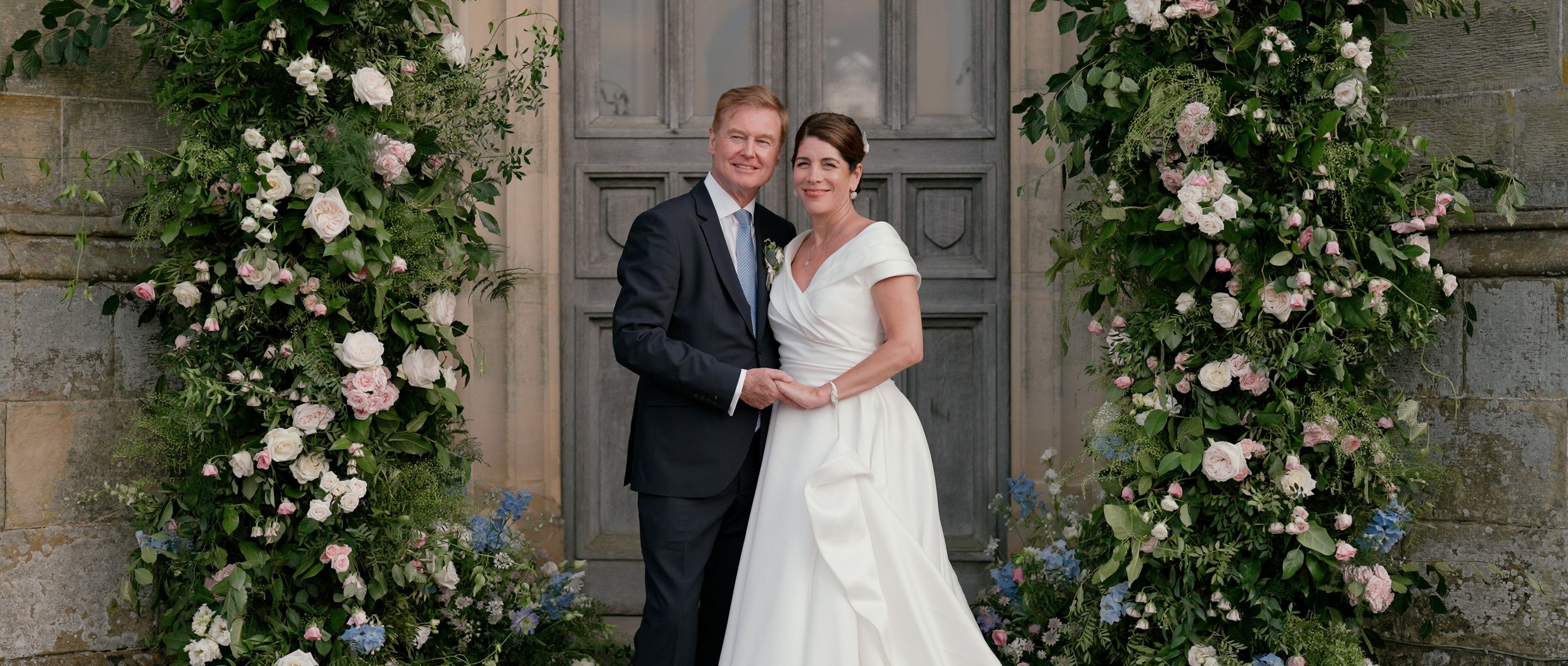 Married couple standing in front of Chiddingstone Castle in Kent