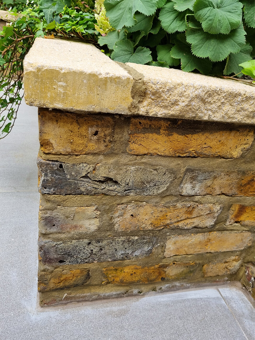 merging new and old material, london stone tiles, coping stone on brick wall, garden design detail, luxury garden design, kensington garden design, small garden design