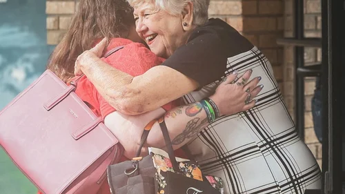 Two church members greeting one another before worship