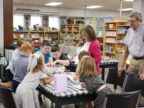 Church members studying the Bible together around tables