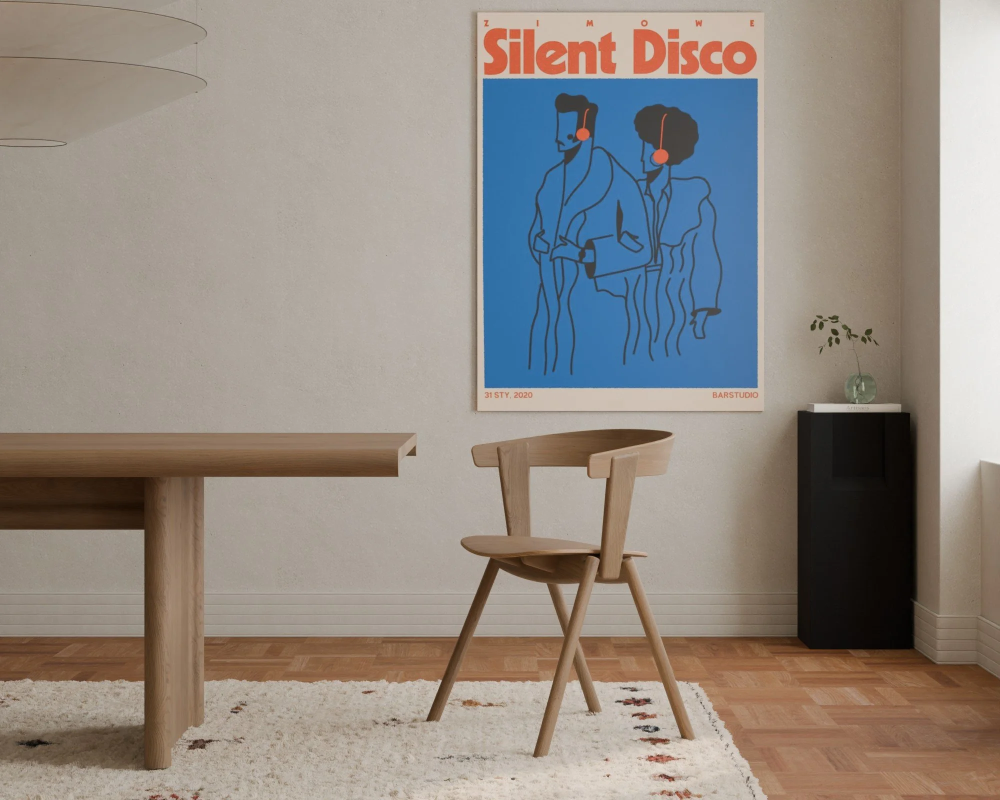 Interior of a minimalist room with a wooden dining table, a wooden chair, a black cabinet, a small plant in a glass vase, and a large poster on the wall titled 'Silent Disco'.