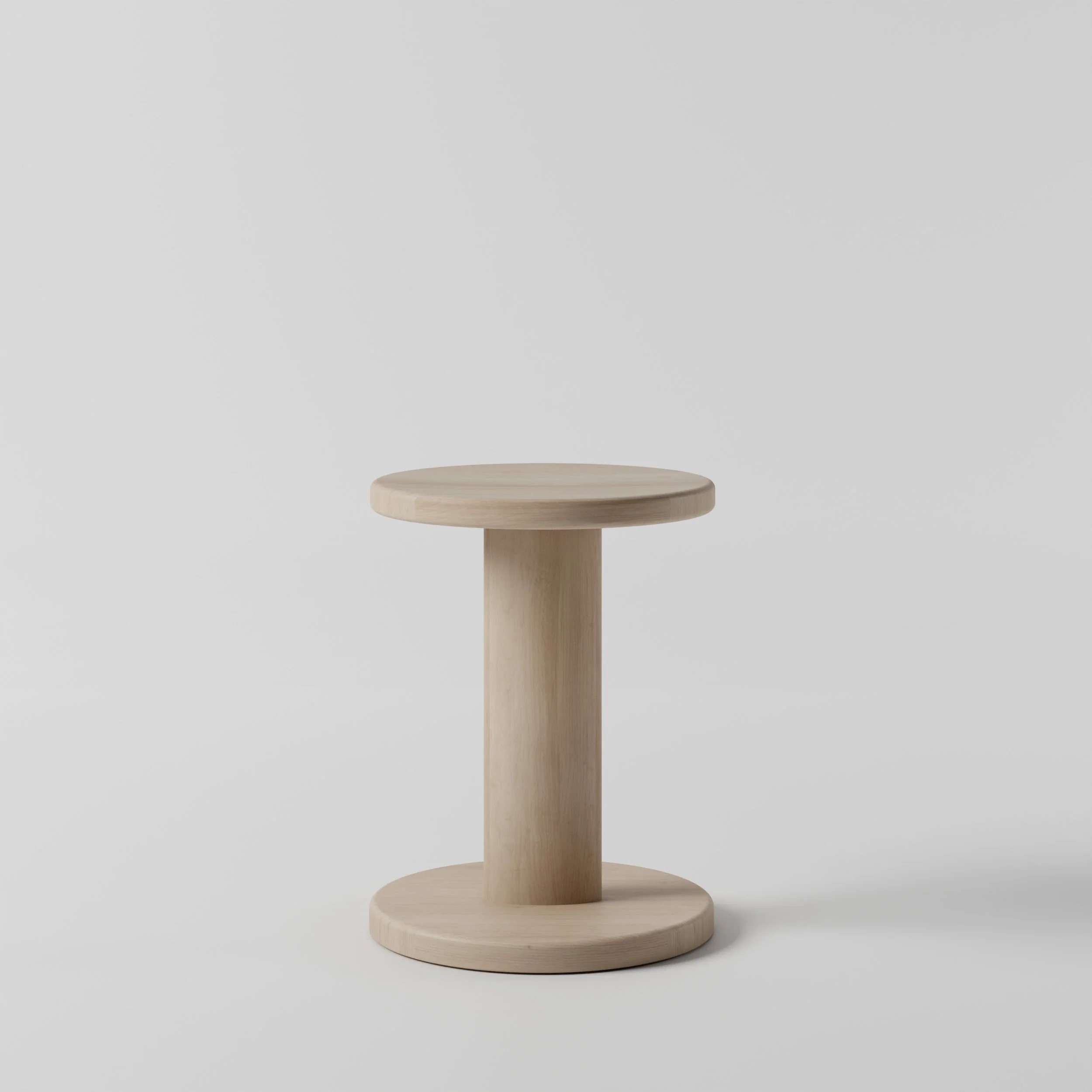 A small round wooden stool with a pedestal base, set against a plain white background.