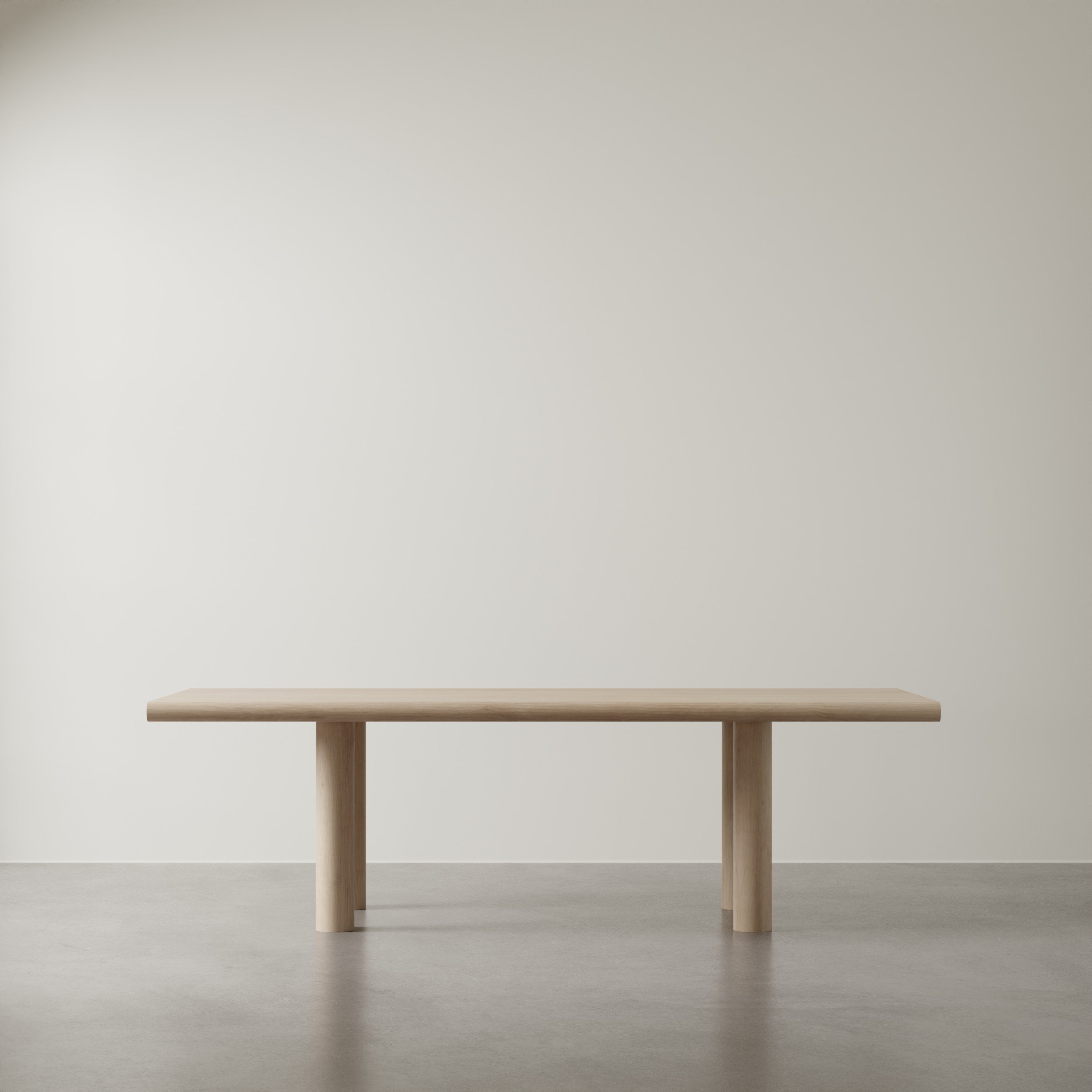 Minimalist wooden table against a neutral, off-white wall.