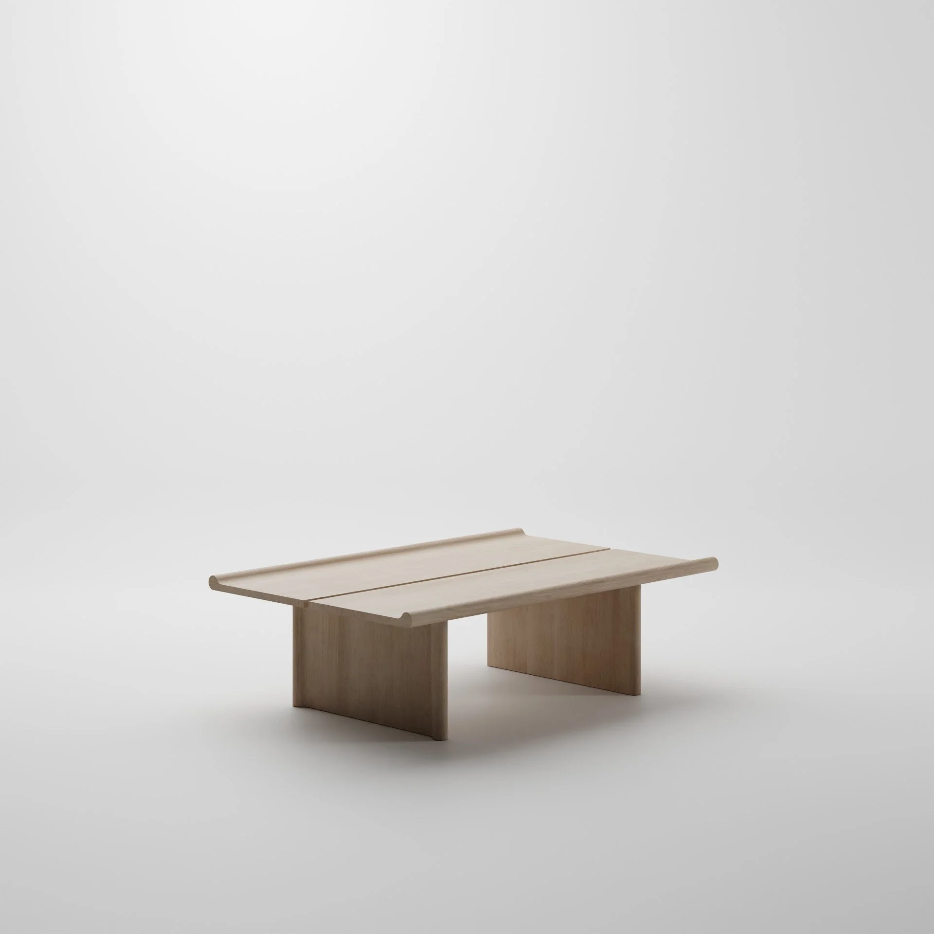 Minimalist wooden table with a smooth surface and rounded edges, set against a plain white background.