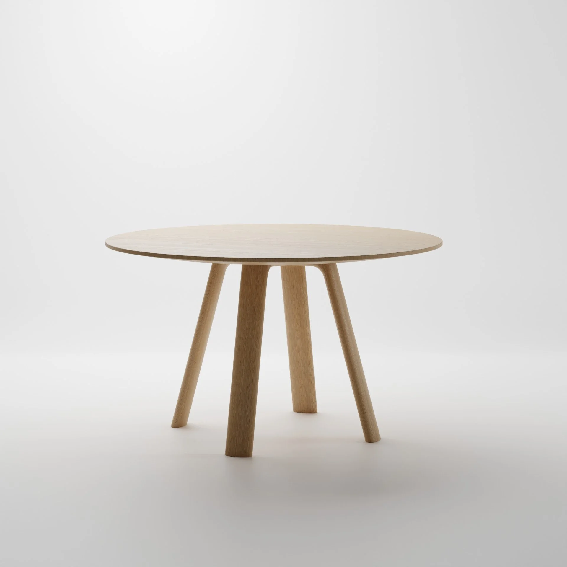 A round wooden table with four angled legs is centered against a plain white background.