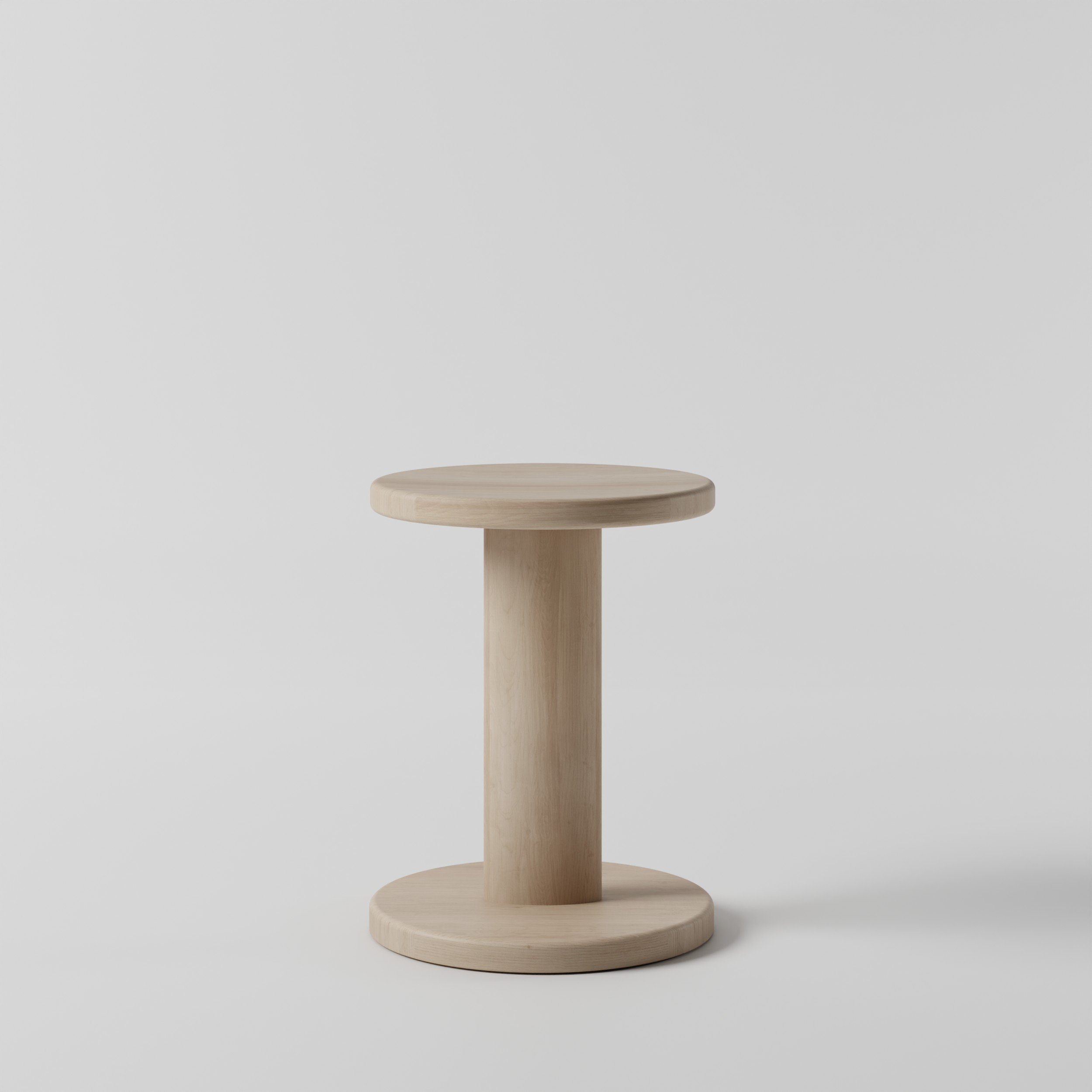 Unsmall light-colored wooden table with a round top and a single round base, set against a plain light gray background.