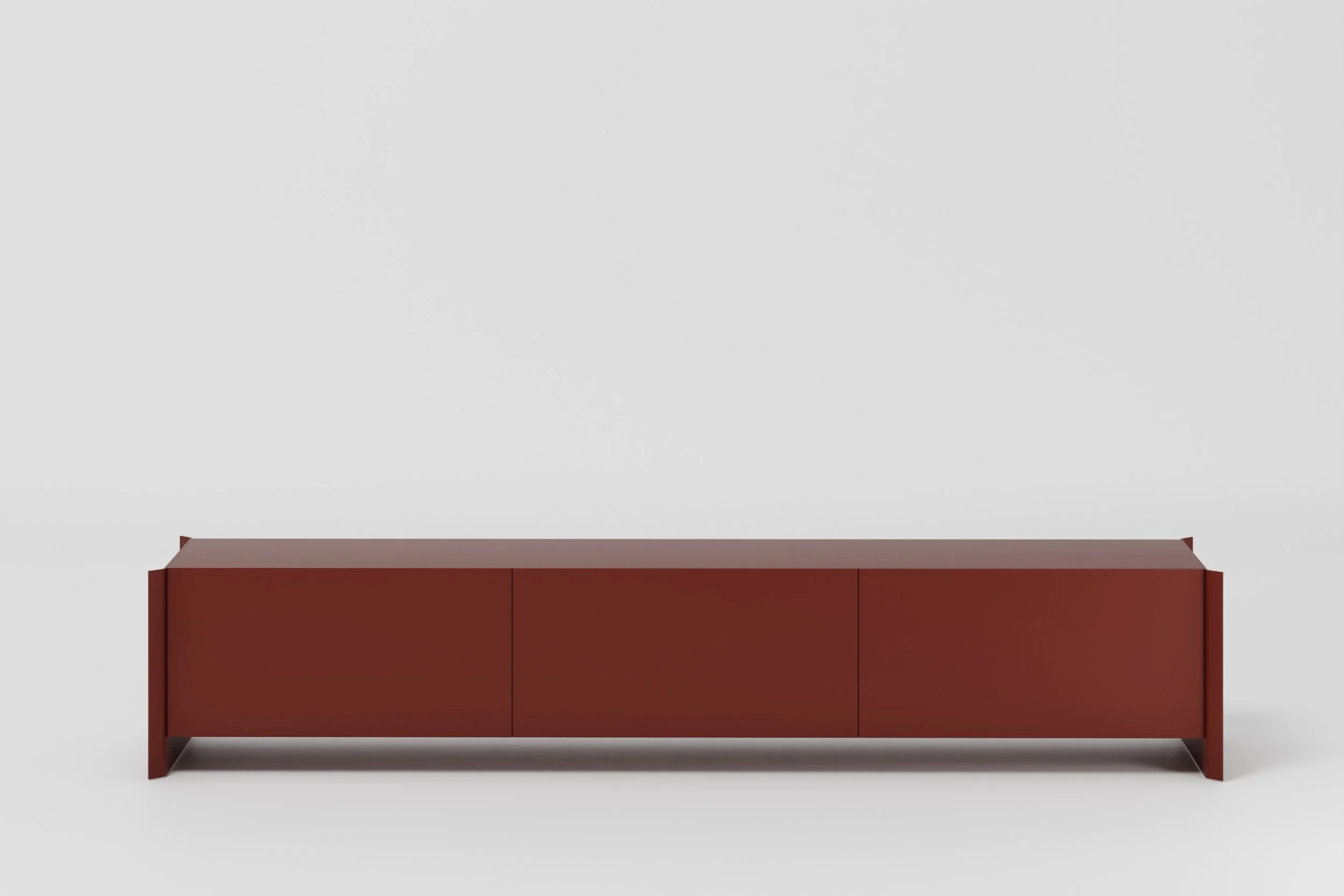 A minimalist modern red cabinet with three closed doors on a light gray background.
