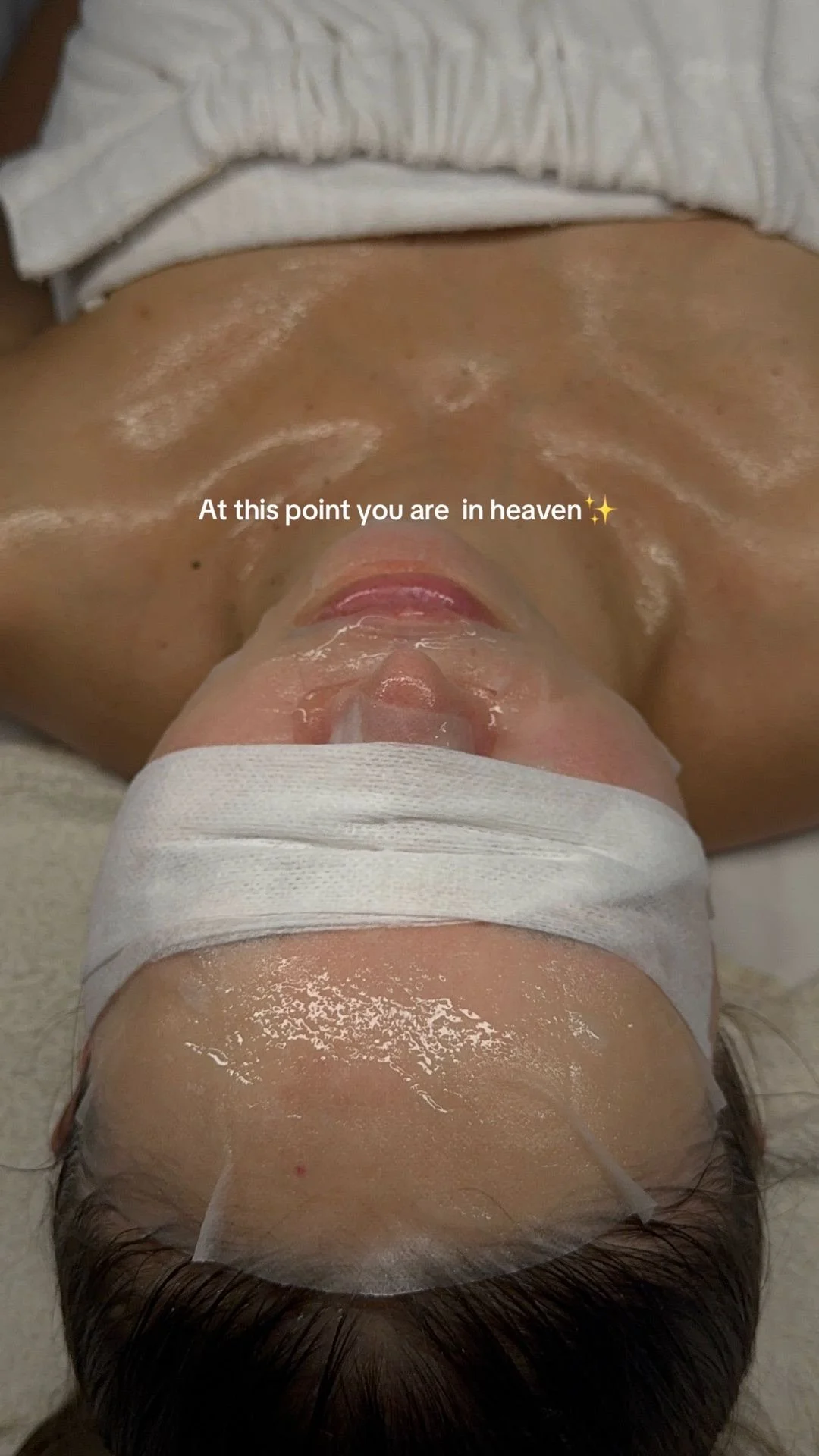 A person lying down with their head wrapped in a white cloth, and a white substance on their skin, with text overlay that says, "At this point you are in heaven".