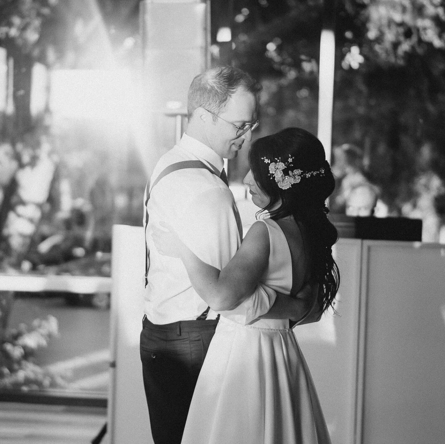 I just love how this photo turned out in black and white! It really shows off the couple well and accents the gorgeous lighting shining on the window. ⁠
⁠