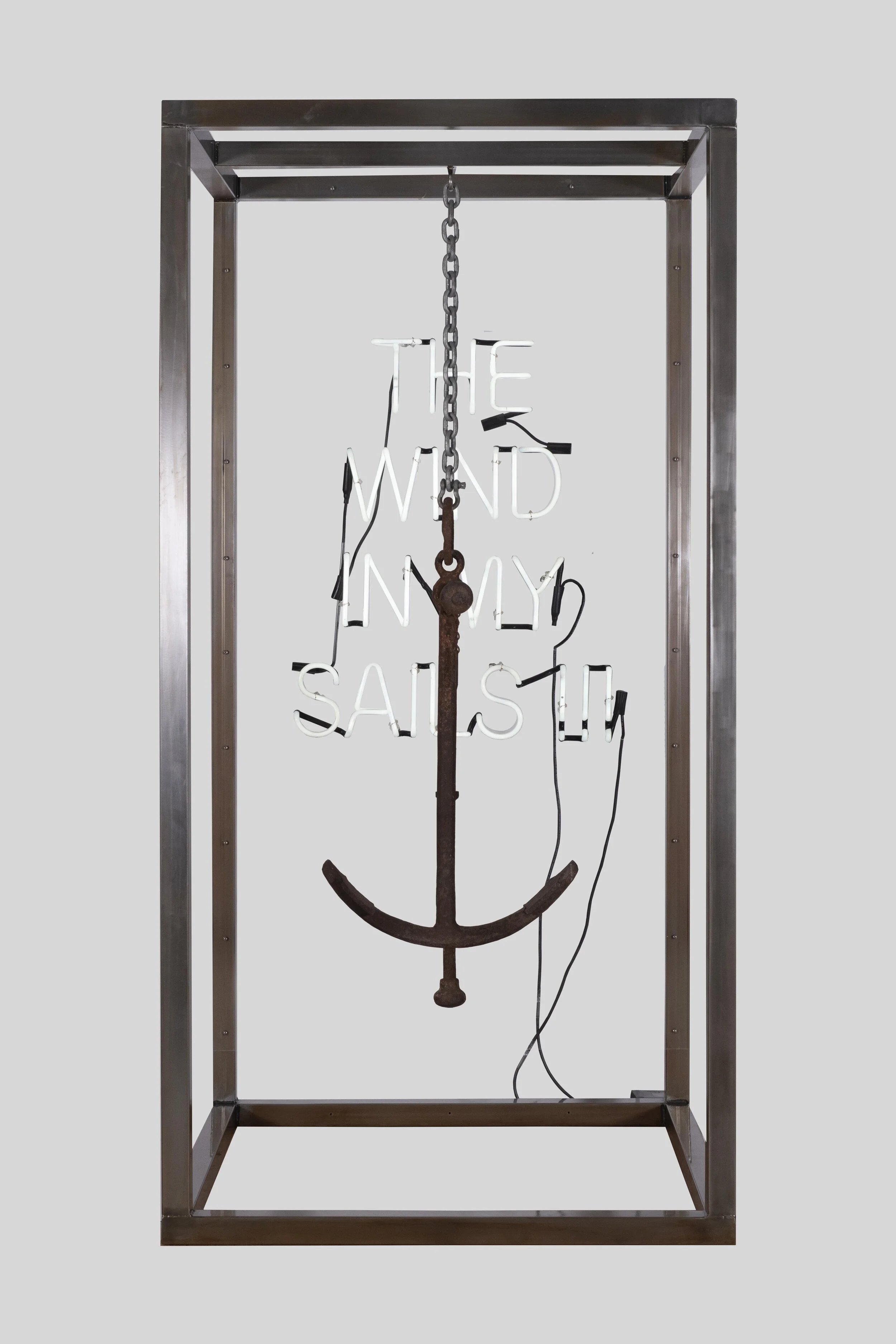 A metal frame with an anchor and a neon sign that says "The wind in my sail".