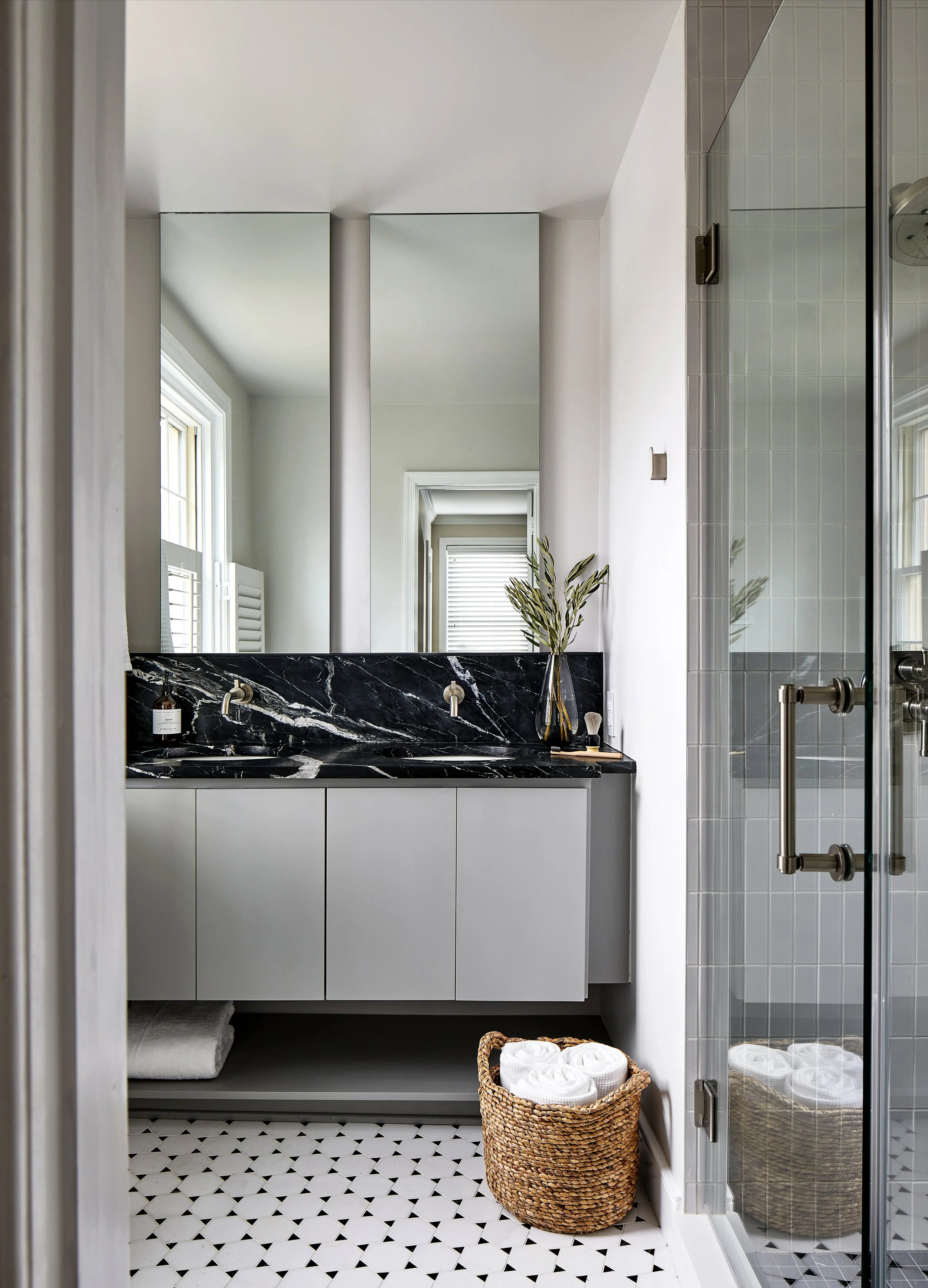 Custom, Modern, hospitality driven bathroom, small space, bespoke cabinetry, black backsplash, backlit mirrors