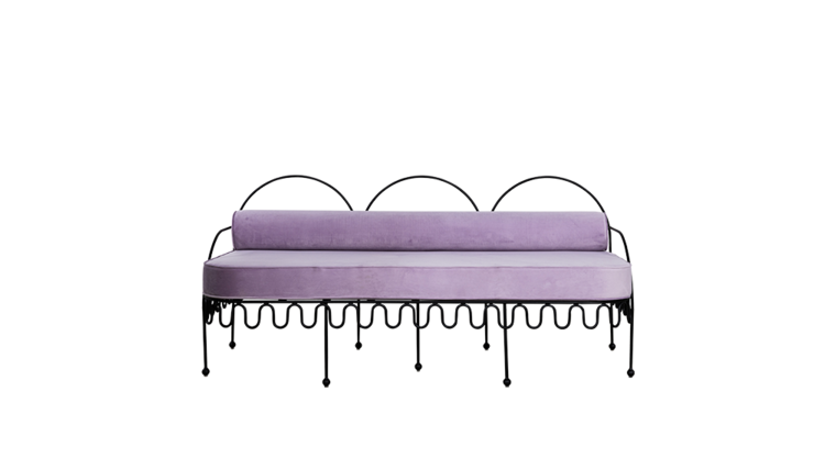 A purple velvet sofa with a black metal frame and decorative metal loops along the bottom edge, set against a plain white background.