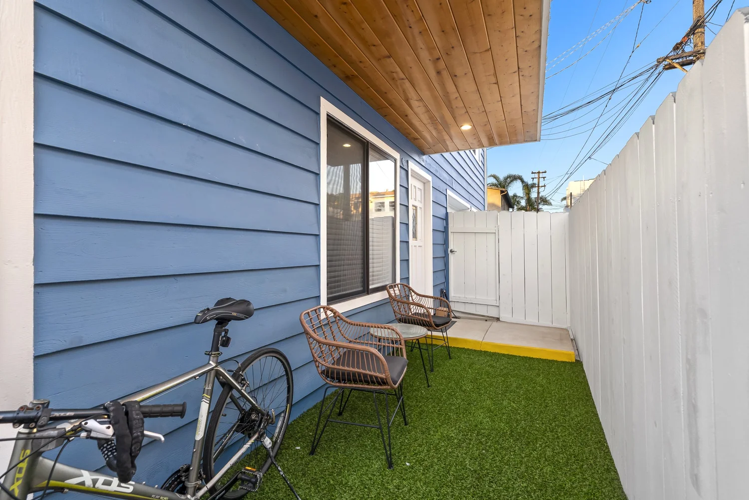 Side yard with turf along the blue siding