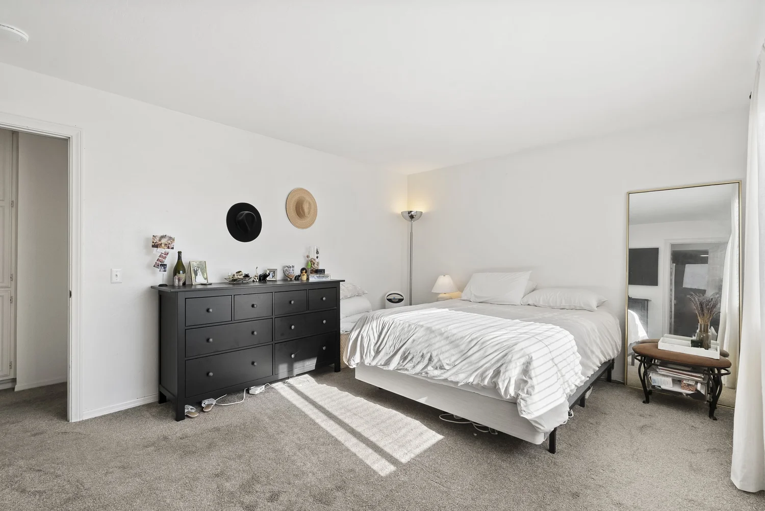 Primary bedroom with dresser and full-length mirror
