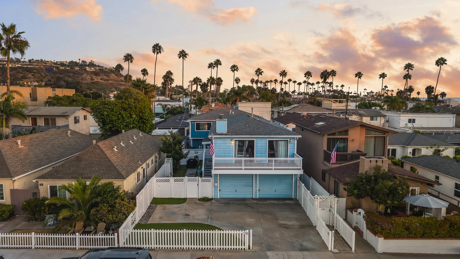 Aerial of 429–433 Nautilus St at sunset: both homes and the front yard