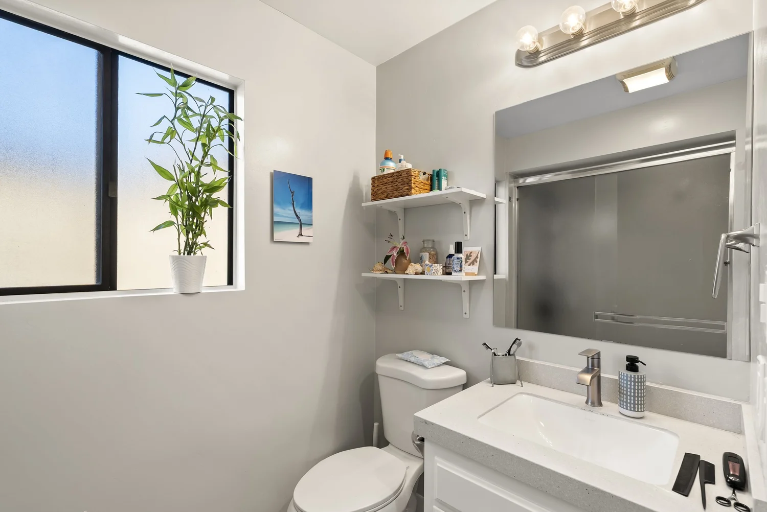 Bathroom with vanity, mirror and window