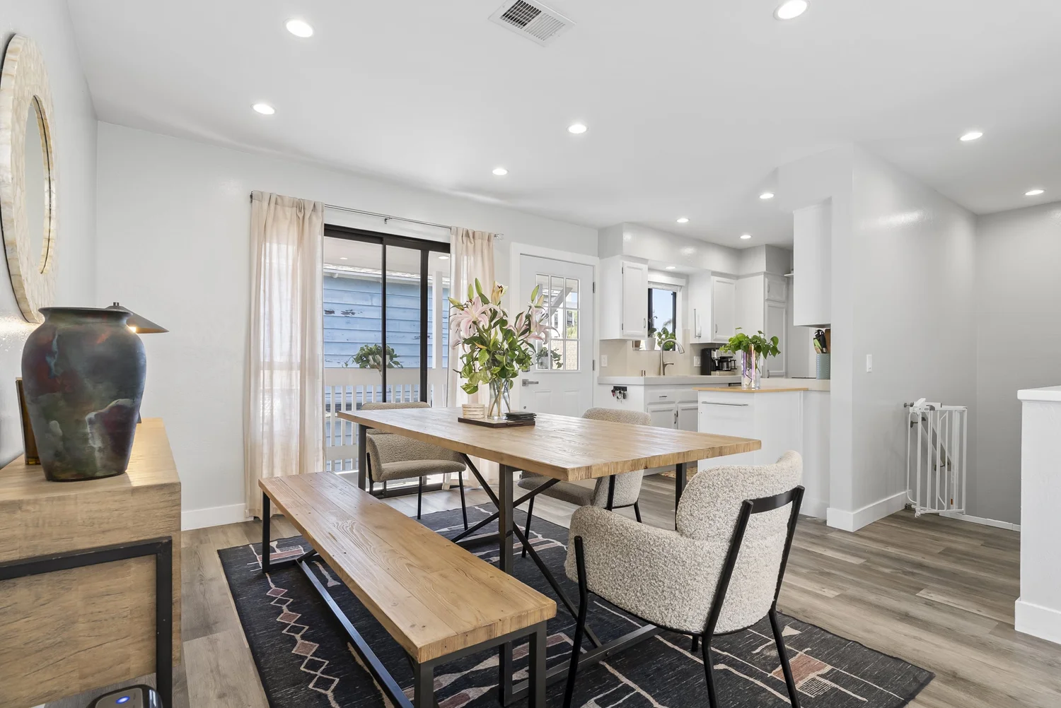 Dining area with farmhouse table and bench, open to the kitchen