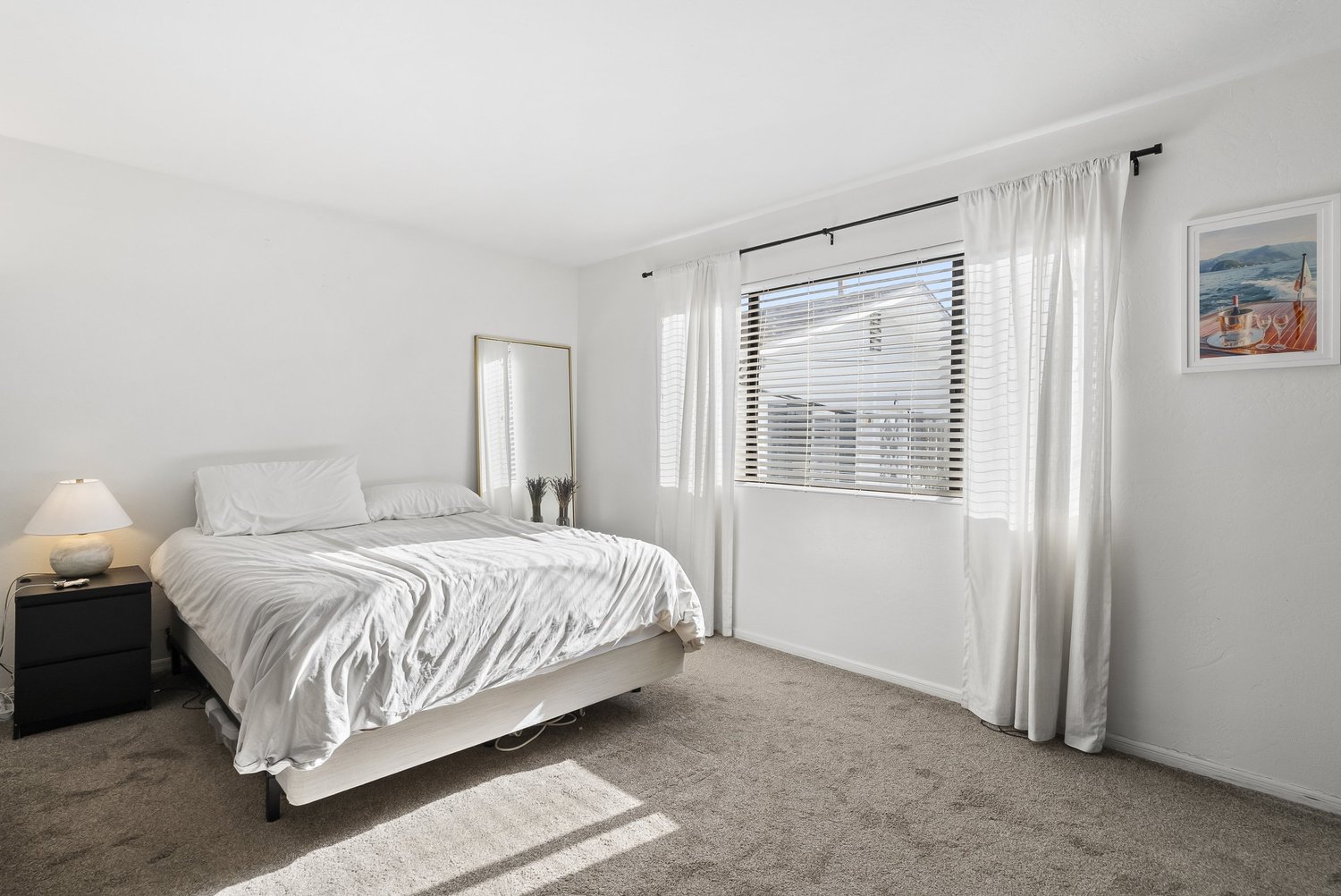 Bedroom with queen bed and large window